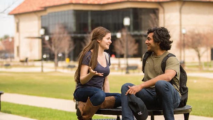 two students talking outside